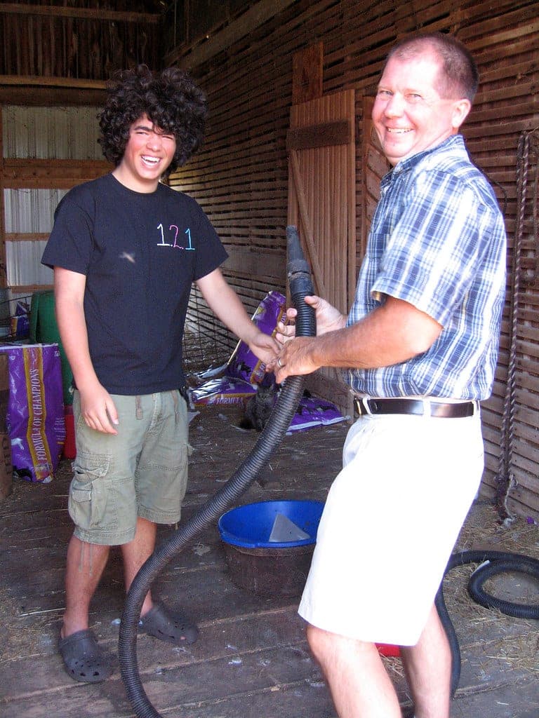 A forced-air dryer nozzle directed at a damp coat